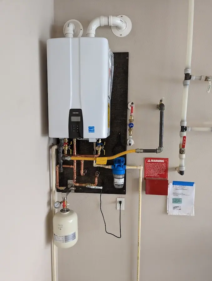 Professional plumber installing copper piping in a Greer home